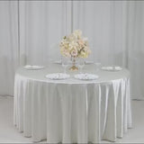 Pearl white round tablecloth with rhinestone accents on a dining table.