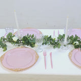 Blush round charger plates with gold embossed rim on a stylish dinner table.