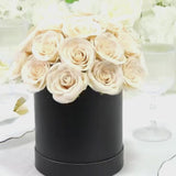 Ivory rose centerpiece arrangement in a black gift box.
