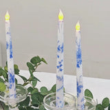 White and blue flameless LED taper candles in glass holders.