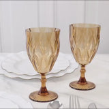 Amber gold vintage diamond cut plastic goblets on a table.