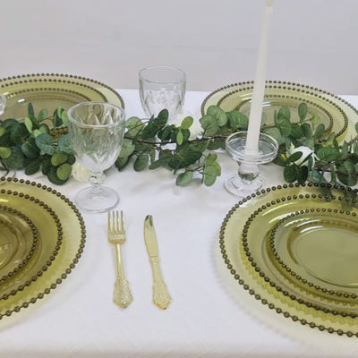 Transparent dusty sage green charger plates with beaded rim for stylish dining.