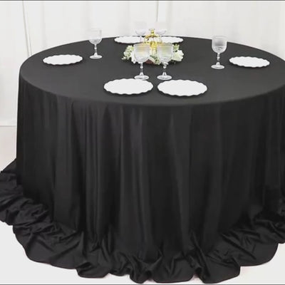 Black fire retardant scuba tablecloth, 132" round, wrinkle-free and stain-resistant.