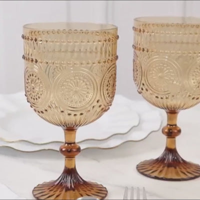 Amber gold vintage plastic wine goblets with embossed floral pattern.