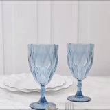 Dusty blue vintage diamond cut plastic goblets on a table.