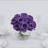 Purple artificial silk roses in a glass vase for floral arrangements.