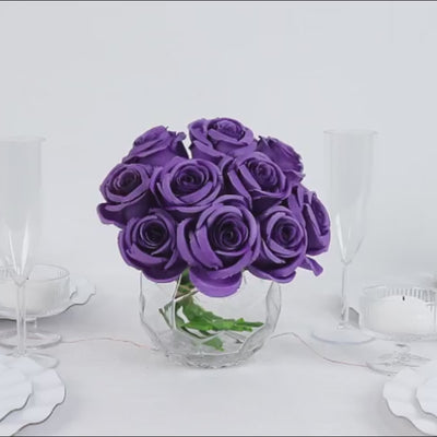 Purple artificial silk roses in a glass vase for floral arrangements.