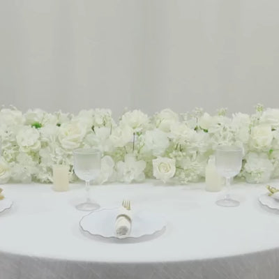 White silk flower table runner with roses and hydrangeas for wedding decor.