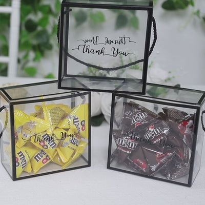 Clear PVC gift boxes with black edge handles, filled with candy and "Thank You" print.