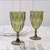 Dusty sage green vintage diamond cut plastic goblets on a table setting.