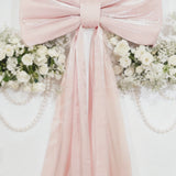 Blush pink bow tie décor for wedding and event backdrops.