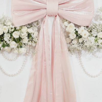 Blush pink bow tie décor for wedding and event backdrops.