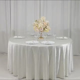Pearl white round tablecloth with rhinestone accents on a dining table.