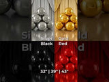 Colorful decorative spheres in silver, gold, black, and red displayed in a stylish arrangement.