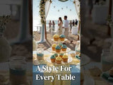 Cupcake display at a beach wedding with decorative elements and a scenic backdrop.
