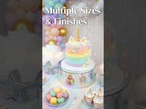 Colorful unicorn cake with pastel decorations and assorted sweets on a festive table.