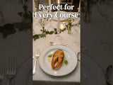Salmon dish elegantly served on a white plate at a beautifully set dining table.