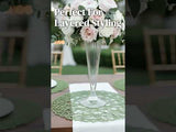 Elegant floral arrangement in a tall vase for layered table styling.