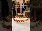 Elegant dessert display at a social gathering, showcasing treats and décor.