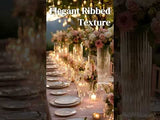 Elegant ribbed texture on a beautifully set table with flowers and candles.