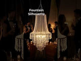 Elegant chandelier with crystal accents illuminating a festive gathering.