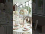 Elegant spiral floral centerpiece on a beautifully set dining table.