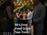 Couple enjoying drinks at a stylish outdoor gathering, surrounded by string lights.