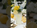 Versatile glass for every drink, styled with lemons and fresh flowers.