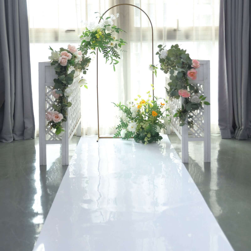 Glossy white aisle runner with floral arch setup