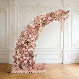 Floral arch installation with pink roses and peonies in an elegant setting.