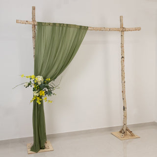 Wooden arch with green drapery and floral arrangement