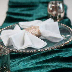 Teal velvet tablecloth with folded napkin place setting
