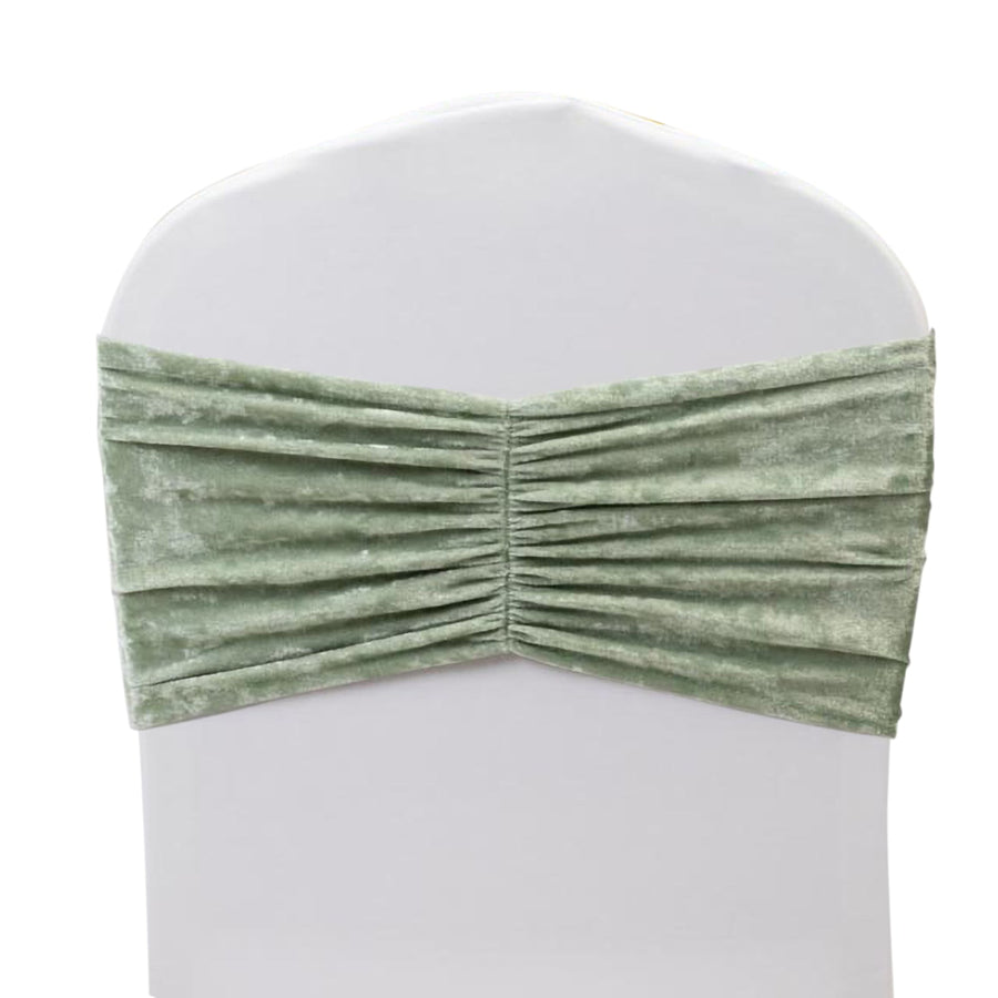 Green velvet chair cover with gathered fabric detail.