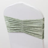 Green velvet chair sash with pleated design.