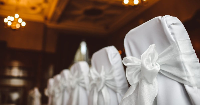 Purple sheer chair sashes on outdoor chairs