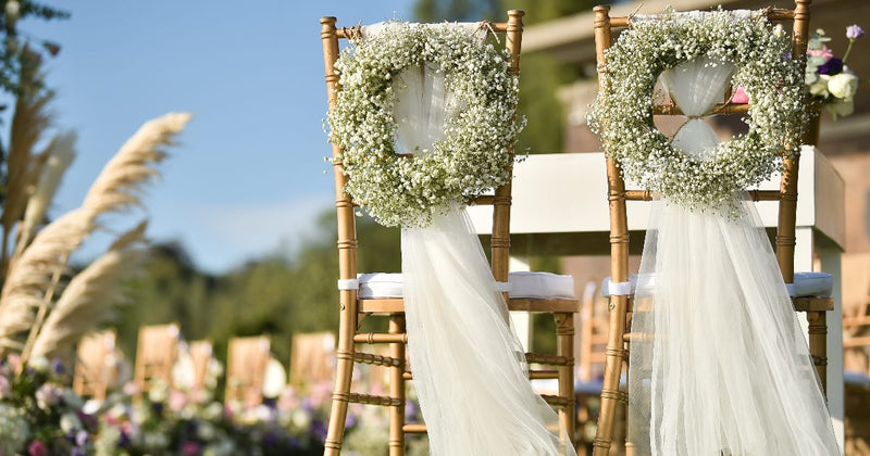 White chair covers with satin bows