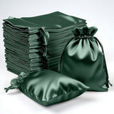 Green satin drawstring bags in various sizes on a white background.