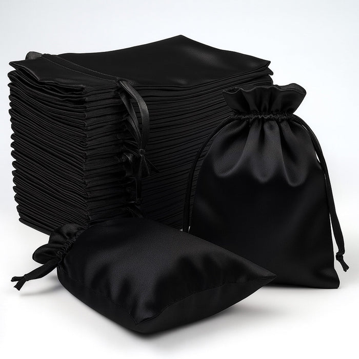 Black satin drawstring bags stacked on a white background.
