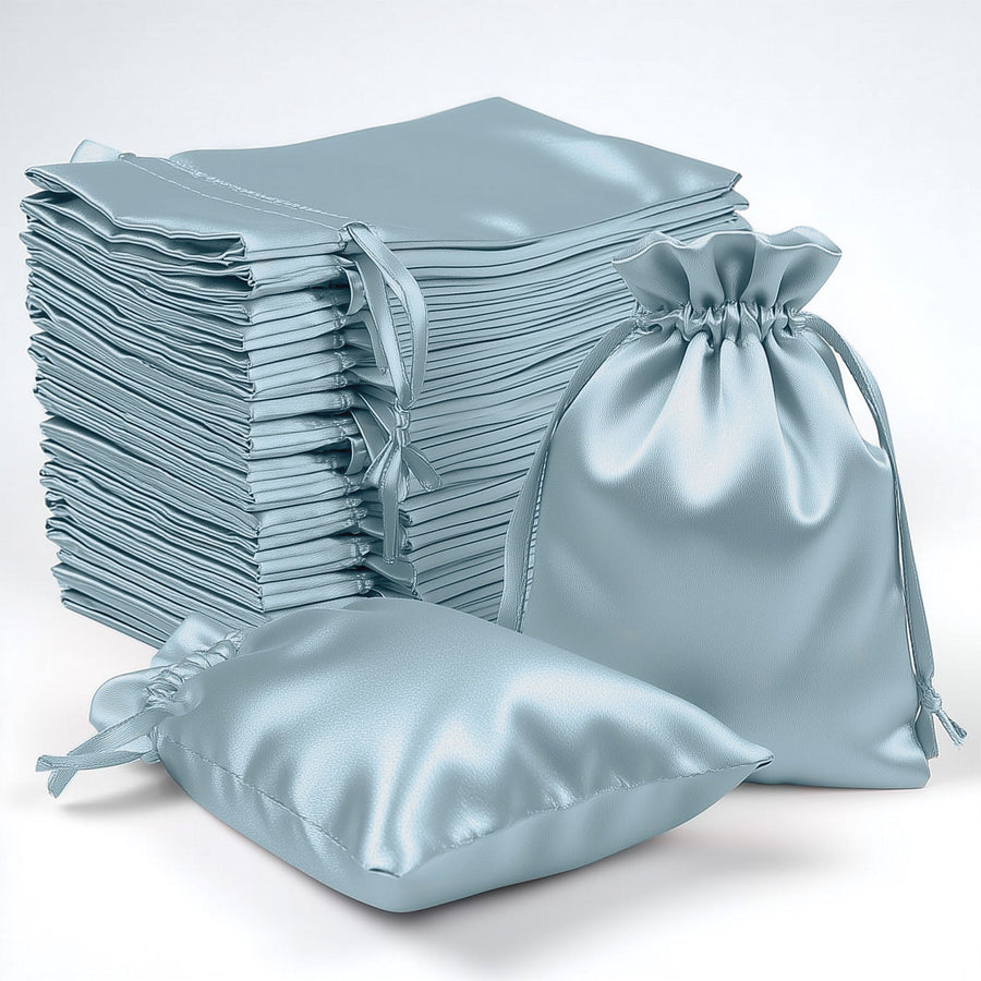 Stack of light blue satin drawstring bags on a white background.