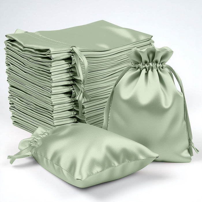 Stack of green satin bags in various sizes on a plain background.