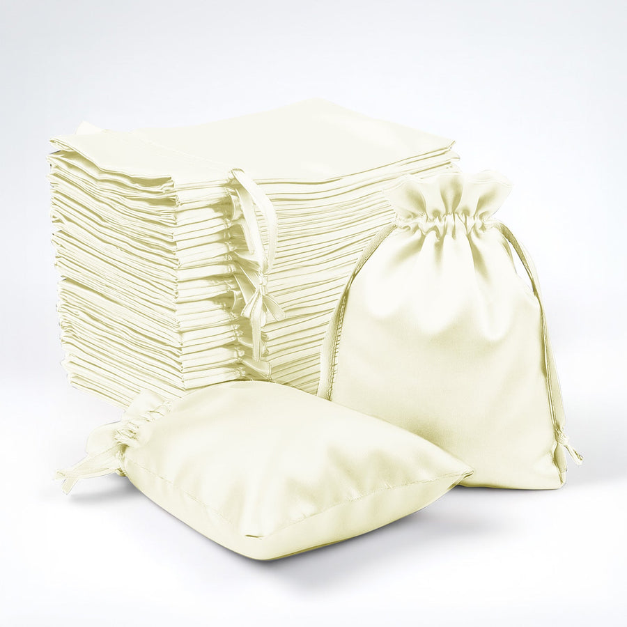 Set of cream fabric bags with drawstrings on a white background.