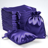 Satin purple drawstring bags stacked and arranged for packaging or gift use
