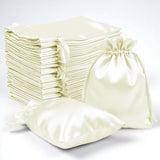 Set of satin drawstring bags in cream color, including various sizes.