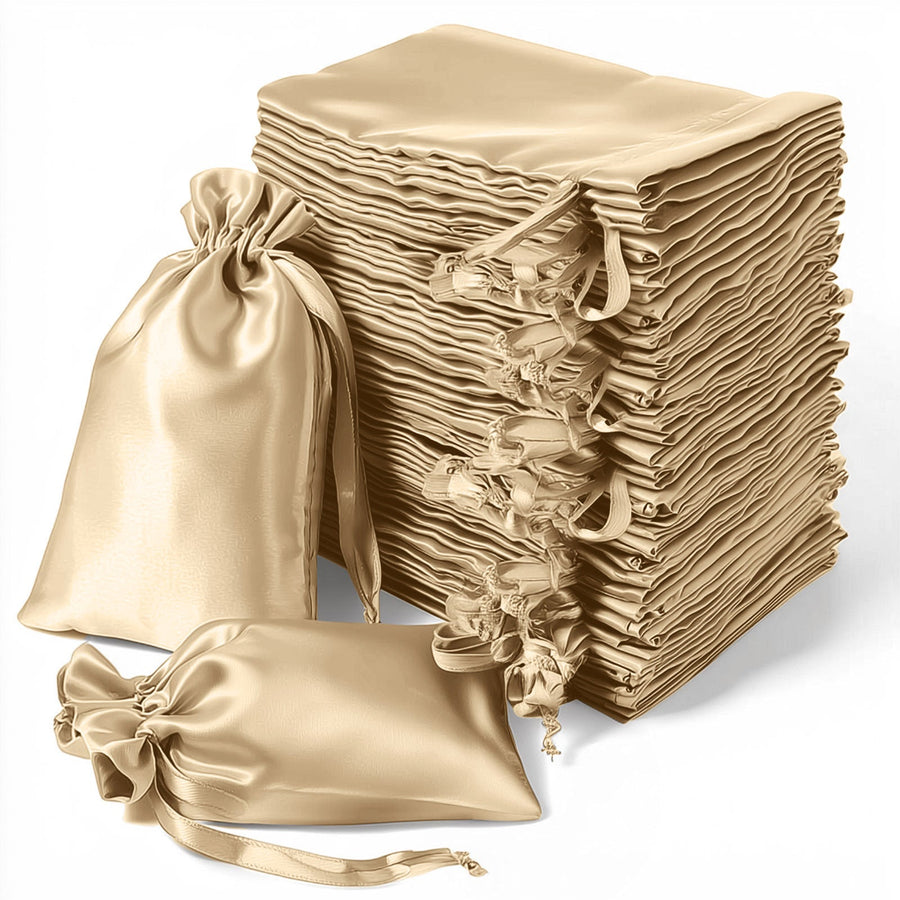 Stack of elegant satin gift bags in beige, with tied closures for special occasions.