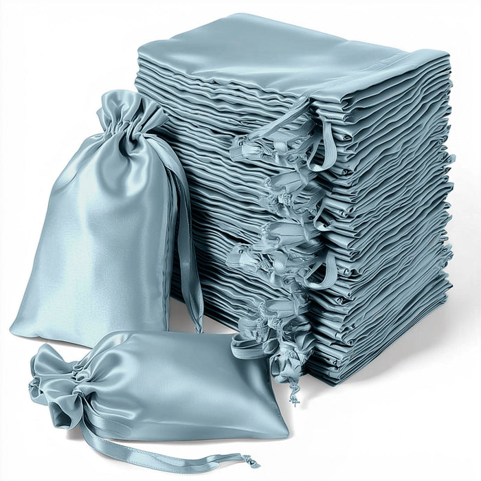 Stack of elegant blue satin bags on a white background
