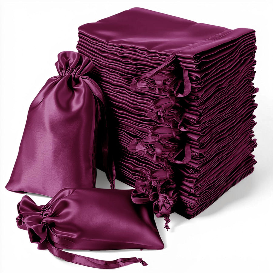Stack of elegant purple satin drawstring bags for gifts and storage