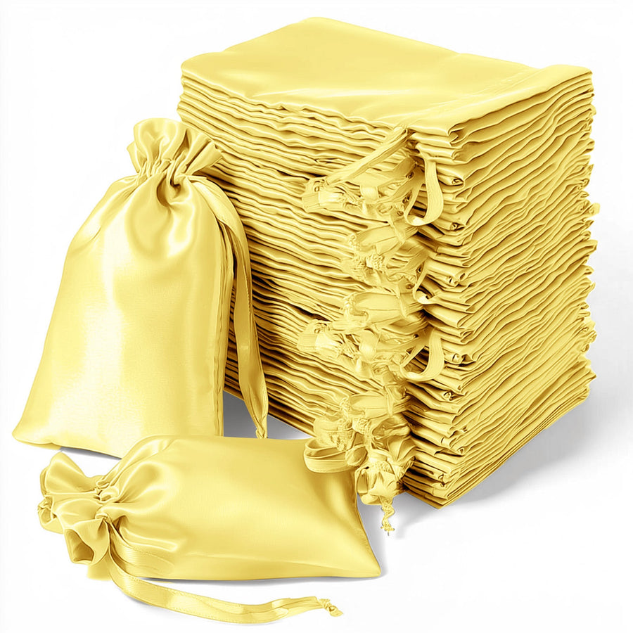 Stack of yellow satin drawstring bags for gifts or storage