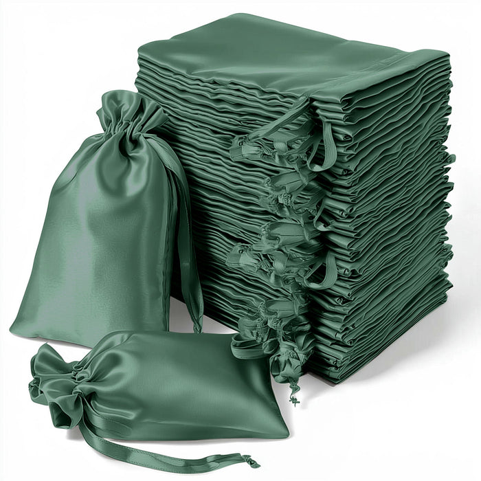 Stack of green satin drawstring bags on a white background.