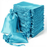 Stack of blue satin drawstring bags for gifts and storage