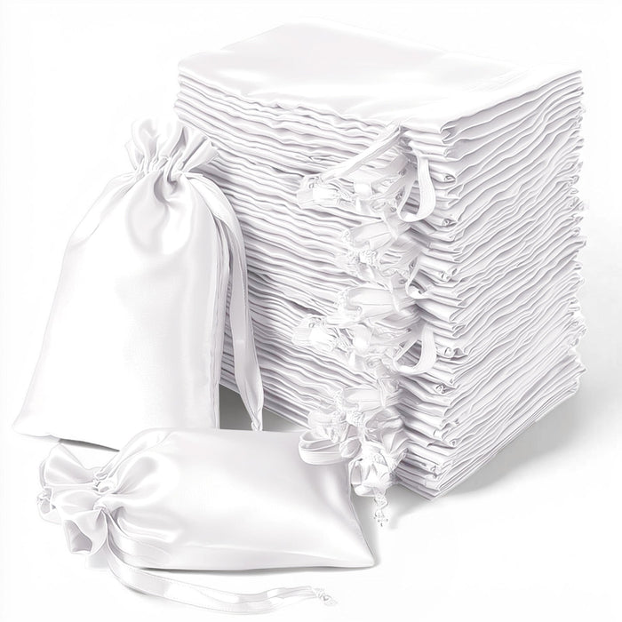 White satin drawstring bags stacked in a neat pile.